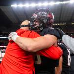 Archbishop Murphys Jack Sievers hugs his coach after winning the 2A state championship game against Tumwater at Husky Stadium on Saturday, Dec. 6, 2025 in Seattle, Washington. (Olivia Vanni / The Herald)