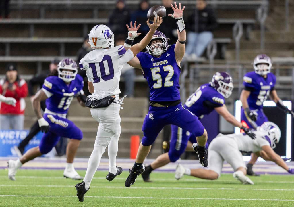 Lake Stevens Brayden Slezak jumps to block a pass by Sumners Brennan Abbott during the 4A state championship game at Husky Stadium on Saturday, Dec. 6, 2025 in Seattle, Washington. (Olivia Vanni / The Herald)