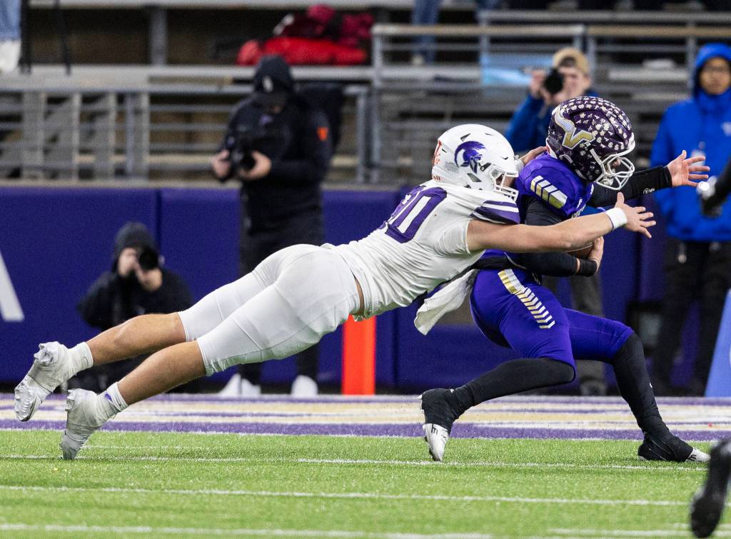 Lake Stevens Blake Moser is tackled during the 4A state championship game against Sumner at Husky Stadium on Saturday, Dec. 6, 2025 in Seattle, Washington. (Olivia Vanni / The Herald)