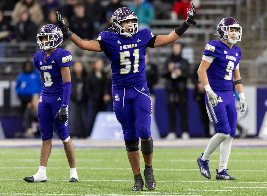 Lake Stevens Kenny Buckmiller raises his arms toward the crowd during the 4A state championship game against Sumner at Husky Stadium on Saturday, Dec. 6, 2025 in Seattle, Washington. (Olivia Vanni / The Herald)
