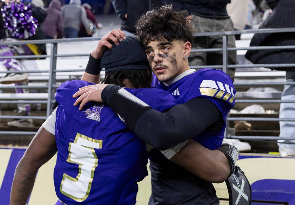 Lake Stevens Blake Moser hugs Jayvian Ferrell after losing the 4A state championship game against Sumner at Husky Stadium on Saturday, Dec. 6, 2025 in Seattle, Washington. (Olivia Vanni / The Herald)
