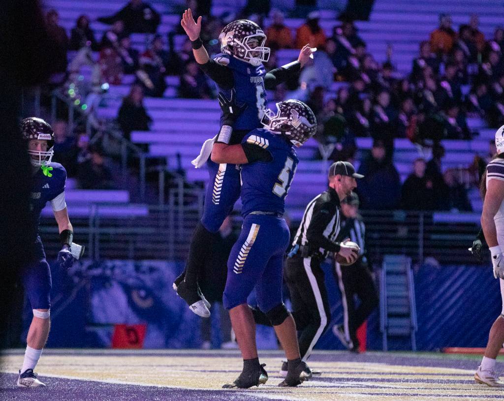 Lake Stevens Kenny Buckmiller lifts up Lake Stevens Blake Moser to celebrate his touchdown during the 4A state championship game against Sumner at Husky Stadium on Saturday, Dec. 6, 2025 in Seattle, Washington. (Olivia Vanni / The Herald)