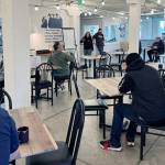 Every morning before lunch service, the community of Everett Recovery Café comes together to discuss their five guiding principles, announce any upcoming events and celebrate new milestones. Photo courtesy Everett Recovery Café