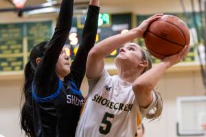 Shorewoods Maya Glasser reaches up to try and block a layup by Shorecrests Anna Usitalo during the 3A district playoff game on Friday, Feb. 14, 2025 in Shoreline, Washington. (Olivia Vanni / The Herald)