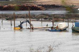 A barge sinks below water near Port Gardner Bay on Wednesday, Dec. 10 in Everett, Washington. (Will Geschke / The Herald)