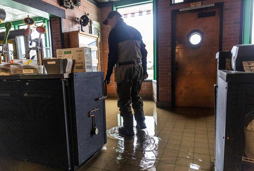 Bob Hammond, an employee at Red Pepper Pizzeria & Pasta, surveys the water damage inside of the restaurant due to flooding from the Skykomish River on Thursday, Dec. 11, 2025 in Sultan, Washington. (Olivia Vanni / The Herald)