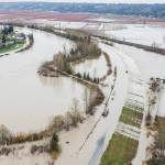 Water from the Snohomish River covers Lowell Snohomish River Road and inundates properties to the west on Thursday, Dec. 11, 2025 in Snohomish, Washington. (Olivia Vanni / The Herald)