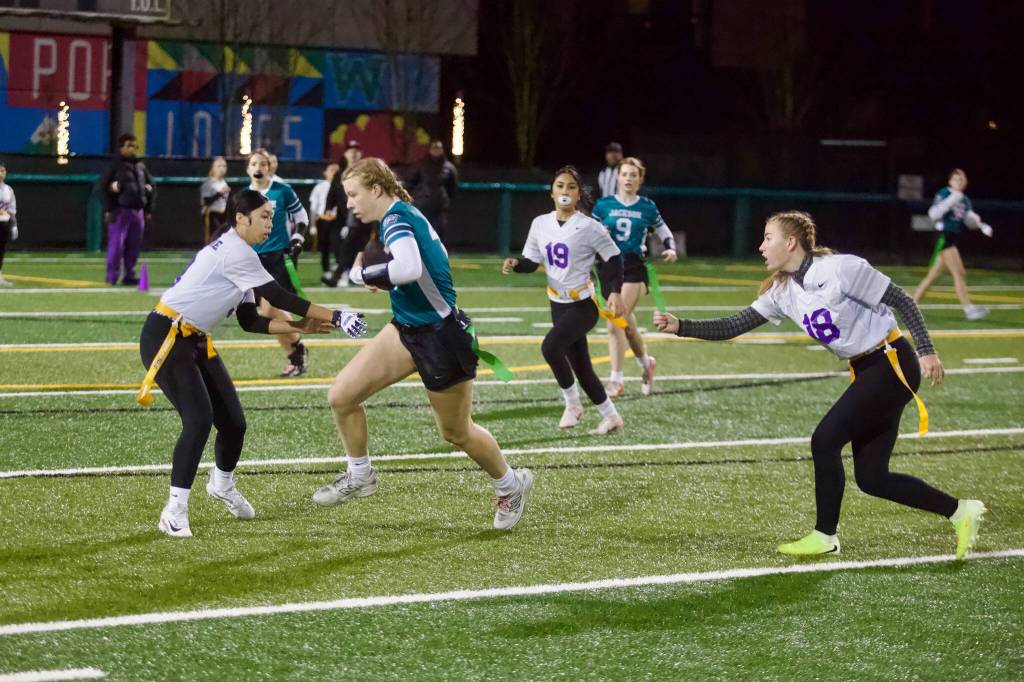 Jackson freshman Clara Dorgan evades Highline defenders after hauling in a long reception during the Timberwolves 23-7 win against the Pirates at Pop Keeney Stadium on Dec. 11, 2025. (Joe Pohoryles / The Herald)