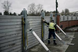 Jsason Phipps of the City of Mount Vernon tightens straps on the flood wall along the Skagit River in downtown Mount Vernon on Thursday. The river is forecast to crest on Friday morning after several days of heavy rain pushed waterways in the region to record levels. (Grant Hindsley/The New York Times)