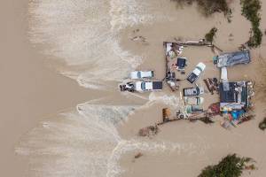 Water from the Snohomish River surrounds a residence along the west side of Lowell Snohomish River Road on Thursday, Dec. 11, 2025 in Snohomish, Washington. (Olivia Vanni / The Herald)