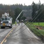 Snohomish County PUD crews work to repair power lines on Wednesday along Marine Drive in Stanwood. (Will Geschke / The Herald)