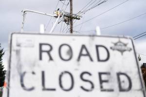 Snohomish County PUD crews work to repair power lines on Wednesday, Dec. 17 along Marine Drive in Stanwood, Washington. (Will Geschke / The Herald)