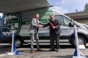 Snohomish County Health Department Director Dennis Worsham and Snohomish County Executive Dave Somers shake hands after cutting the ribbon during the unveiling of the health departments Health on Wheels Van, a mobile public health unit, on Wednesday, April 9, 2025 in Everett, Washington. (Olivia Vanni / The Herald)
