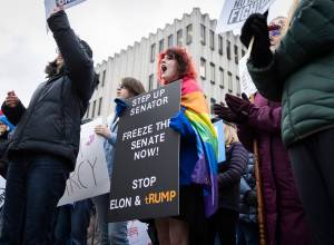 Ari Smith, 14, cheers in agreement with one of the speakers during Snohomish County Indivisibles senator office rally at the Snohomish County Campus on Wednesday, Feb. 5, 2025, in Everett, Washington. (Olivia Vanni / The Herald)