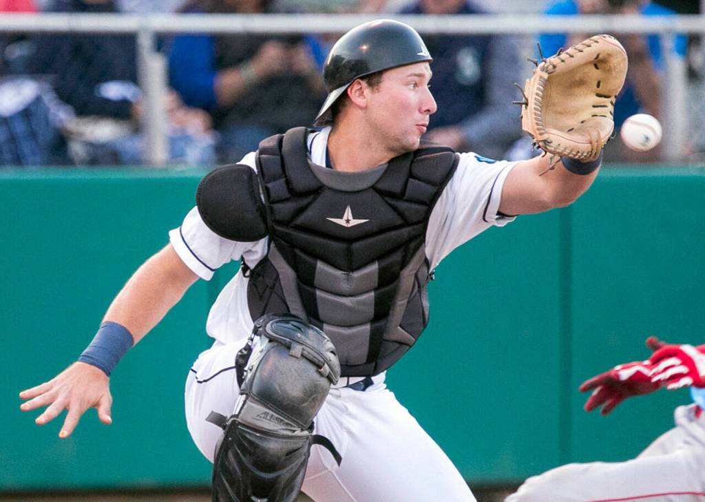 Indians' J.P. Martinez beats the throw to AquaSox's Cal Raleigh for a run in the first inning Wednesday evening at Everett Memorial Stadium in Everett on September 5, 2018.  (Kevin Clark / The Herald)