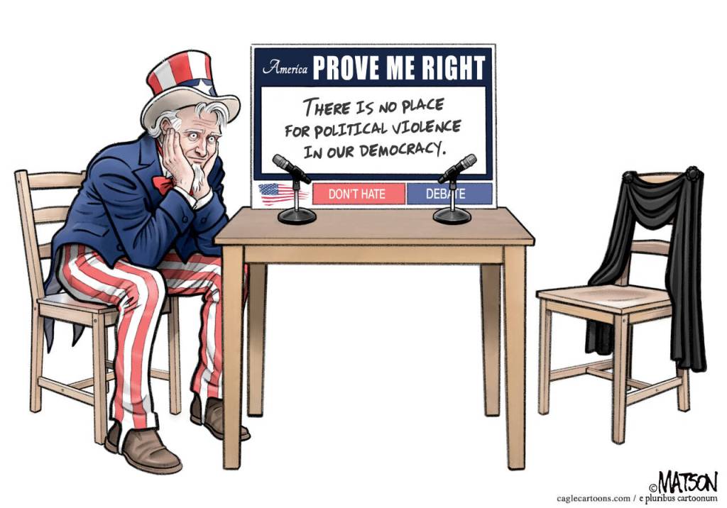 young handsome man in grey sweater sitting on chair isolated on white