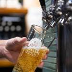 An employee pours a Garage Beer into a Dwellers Drinkery glass on Sept. 25, 2025 in Lake Stevens, Washington. (Olivia Vanni / The Herald)