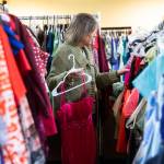 Jana Clark picks out a selection of dress that could be used for prom on Wednesday, May 14, 2025 in Snohomish, Washington. (Olivia Vanni / The Herald)