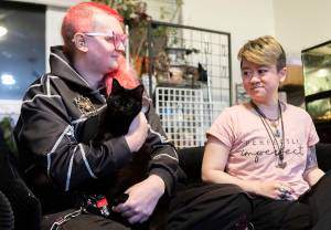 Nolla Rohr holds October while seated on the couch on Tuesday, Jan. 20, 2026 in Lynnwood, Washington. (Olivia Vanni / The Herald)