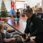 Declan, 5, and Oaklen, 2, play while Boyle puts shoes on Raiden, 4, as she gets her three sons ready to leave for daycare on Tuesday, Dec. 30, 2025 in Marysville, Washington. (Olivia Vanni / The Herald)