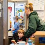 Declan, 5, looks in the fridge during breakfast on Tuesday, Dec. 30, 2025 in Marysville, Washington. (Olivia Vanni / The Herald)