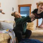 Stephanie Boyle tosses Oaklen, 2, onto a padded mat before getting her sons ready for daycare on Tuesday, Dec. 30, 2025 in Marysville, Washington. (Olivia Vanni / The Herald)
