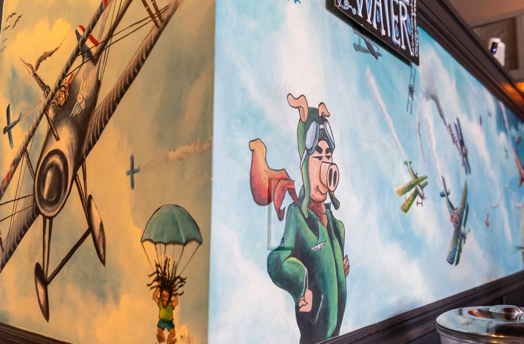 A flying pig inspired mural on the wall inside the restaurant on Monday, Dec. 29, 2025 in Everett, Washington. (Olivia Vanni / The Herald)
