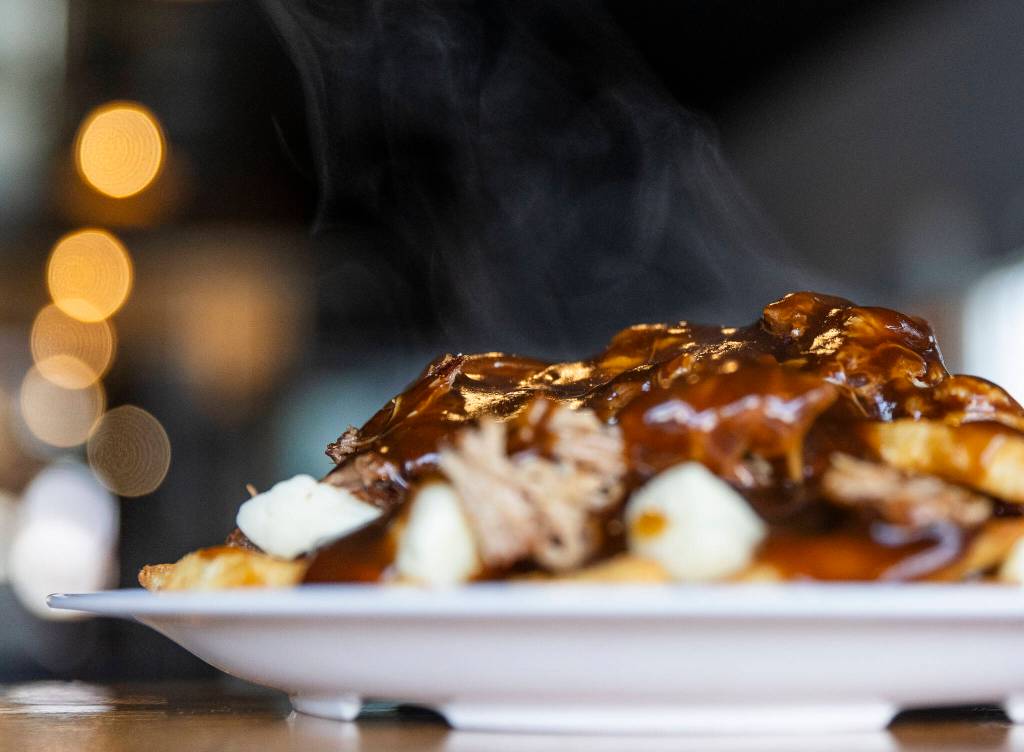 Steam rolls off the Flying Pig&rsquo;s poutine on Monday, Dec. 29, 2025 in Everett, Washington. (Olivia Vanni / The Herald)

