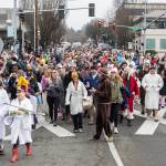 People march down Main Street making their way to Bracketts Landing North to participate in the 19th annual Polar Bear Plunge on Thursday, Jan. 1, 2026, in Edmonds, Washington. (Olivia Vanni / The Herald)