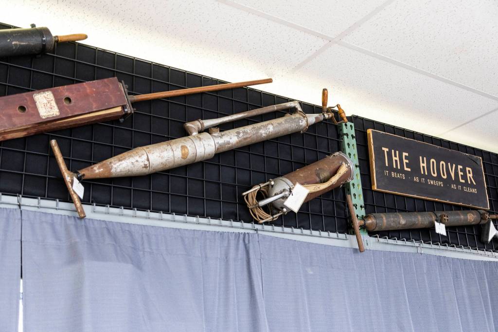 Antique vacuums hang on display inside Everettt Vacuum on Friday, Jan. 2, 2026 in Everett, Washington. (Olivia Vanni / The Herald)