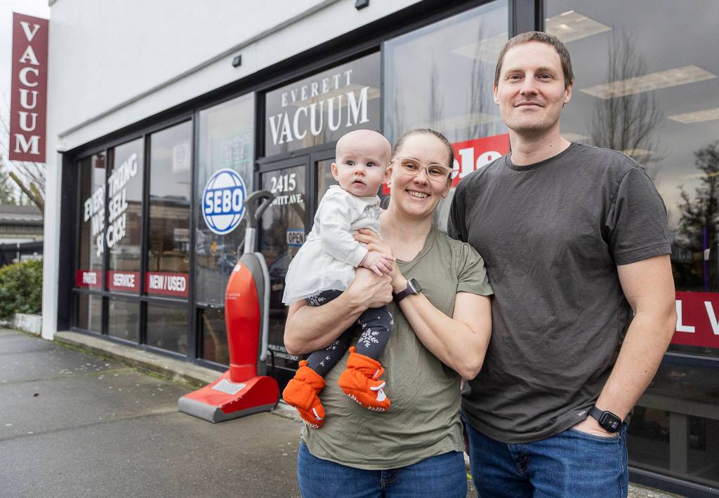 PHOTOS BY Olivia Vanni / The Herald
Everett Vacuum owners Kelley and Samantha Ferran with their daughter Alexandra outside of their business on Friday in Everett.
