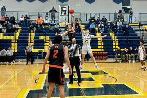 Monroe senior Caleb Campbell (center, in black) wins the opening tip-off in the Bearcats' 77-47 win against Everett at Norm Lowery Gymnasium on Jan. 2, 2026. (Joe Pohoryles / The Herald)