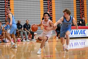Everett CC freshman Bubba Palacol drives past Spokane sophomore Eloy Chaparro during the Trojans' 93-92 overtime loss to the Sasquatch at the Walt Price Student Fitness Center on Jan. 3, 2026. (Daniel Acosta / Everett CC Athletics)
