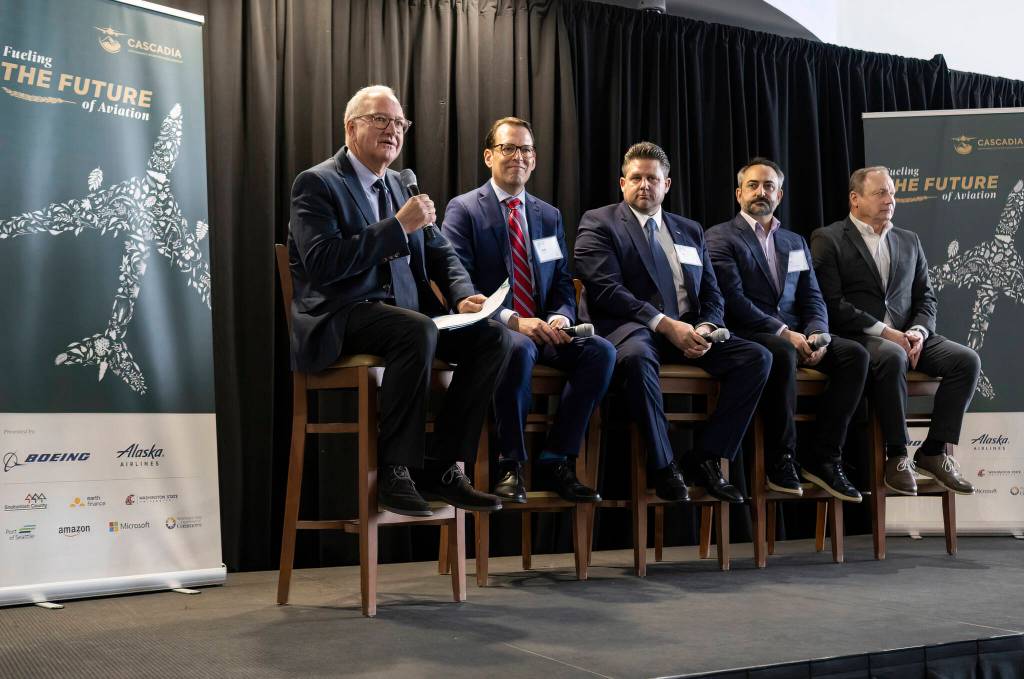 CSAA Board vice chair Tim Zenk (left to right) ask questions of panelists SkyNRG executive Andy Billig, Machinists Union IAM District President Jon Holden, Amazon executive Guy Palumbo and Port of Seattle Director Steve Metruck during an event to announce the launch of the Cascadia Sustainable Aviation Accelerator at the Boeing Future of Flight Aviation Center on Thursday, Jan. 8, 2026 in Everett, Washington. (Olivia Vanni / The Herald)