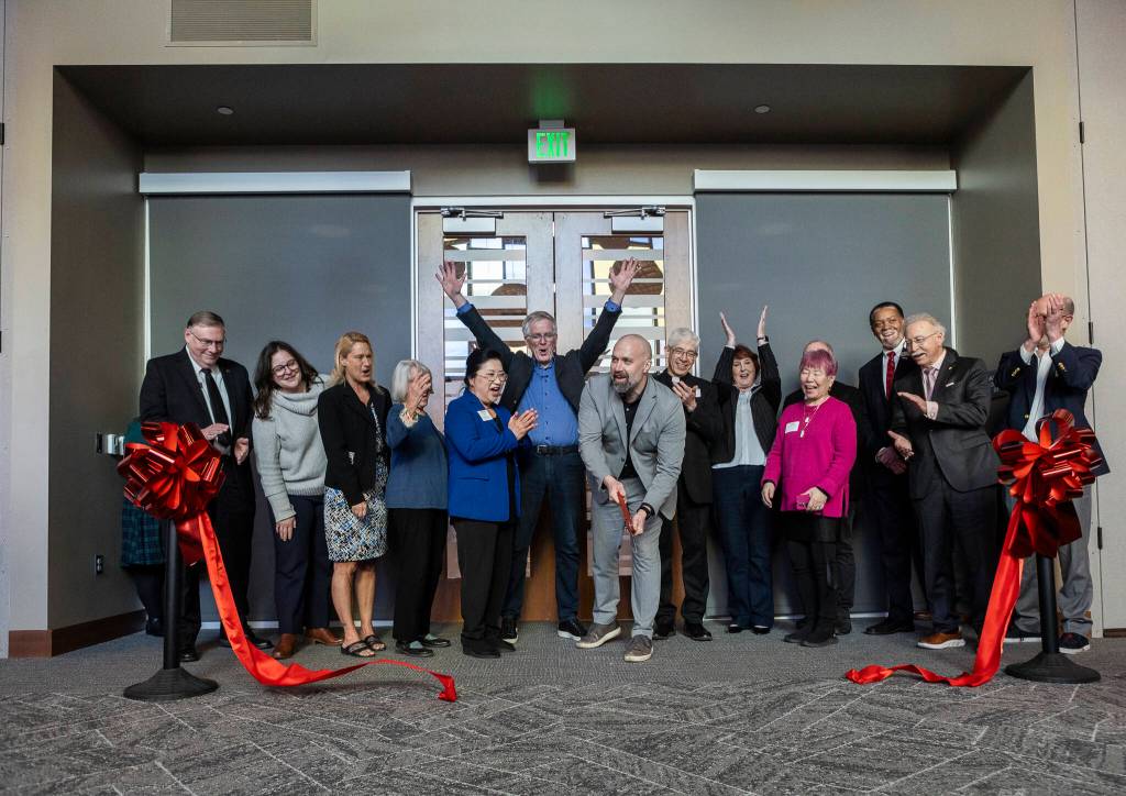 President and CEO of Volunteers of America of Western Washington Brian Smith cut a ribbon during the opening of the Lynnwood Neighborhood Center on Friday, Jan. 9, 2026 in Lynnwood, Washington. (Olivia Vanni / The Herald)