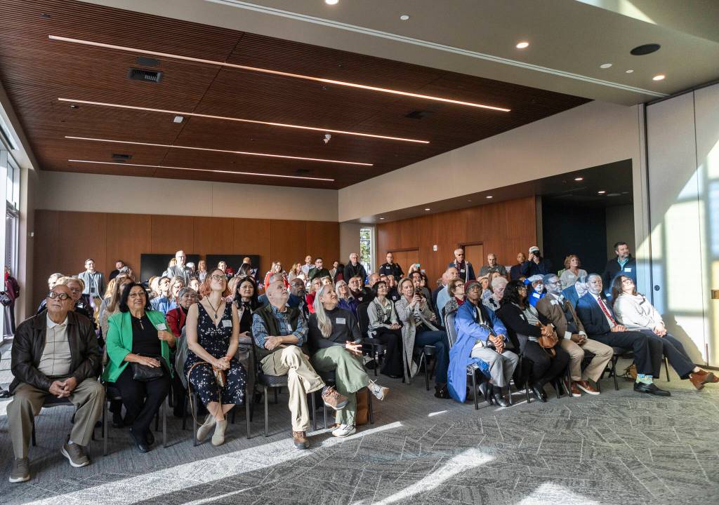 People look up at the colored glass inside the Lynnwood Neighborhood Center on Friday, Jan. 9, 2026 in Lynnwood, Washington. (Olivia Vanni / The Herald)