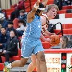 Snohomishs Hudson Smith dribbles the ball up the court while being defended by Meadowdales Hasaan Motley during the game on Monday, Jan. 5, 2026 in Snohomish, Washington. (Olivia Vanni / The Herald)