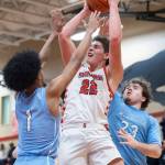 Snohomishs Deyton Wheat makes a shot while Meadowdales Noah Million and Marley Miller defend during the game on Monday, Jan. 5, 2026 in Snohomish, Washington. (Olivia Vanni / The Herald)