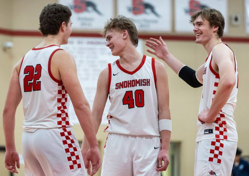 Snohomishs Deyton Wheat, Hudson Smith and Luke Davis laugh during the game against Meadowdale on Monday, Jan. 5, 2026 in Snohomish, Washington. (Olivia Vanni / The Herald)