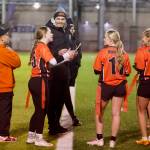 Monroe girls flag football coach Connor Wood (center) speaks to a group of players during a timeout at Everett Memorial Stadium on Jan. 7, 2026. (Joe Pohoryles / The Herald)