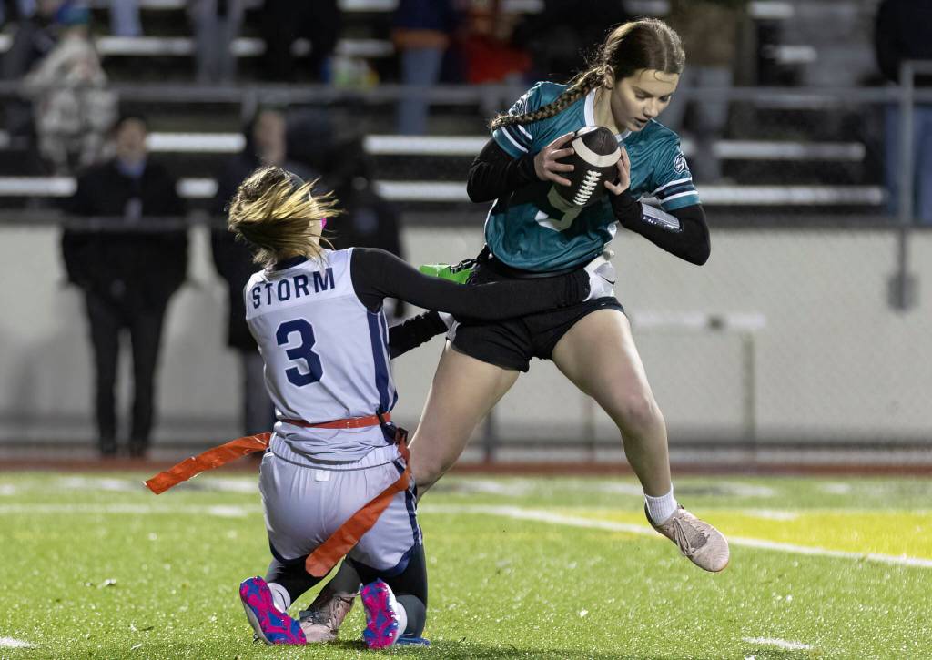 Jacksons Laila Lowery jumps to avoid having her flag pulled during the game against Squalicum on Wednesday, Jan. 7, 2026 in Everett, Washington. (Olivia Vanni / The Herald)
