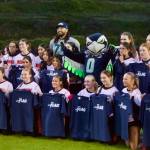 Former Seattle Seahawks offensive lineman Garry Gilliam and Seahawks mascot Blitz pose with the Monroe girls flag football team at Everett Memorial Stadium on Jan. 7, 2026. (Joe Pohoryles / The Herald)