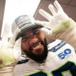 Seattle Seahawks defensive end Leonard Williams shows off his NFC West Champions hat after a win over the San Francisco 49ers on Saturday in a Levis Stadium locker room in Santa Clara, California. (Photo courtesy of Rod Mar / Seattle Seahawks)