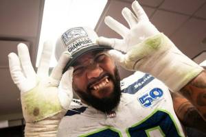 Seattle Seahawks' defensive end Leonard Williams shows off his NFC West Champions hat after a win over the San Francisco 49ers on Saturday in a Levi's Stadium locker room in Santa Clara, California. (Photo courtesy of Rod Mar / Seattle Seahawks)