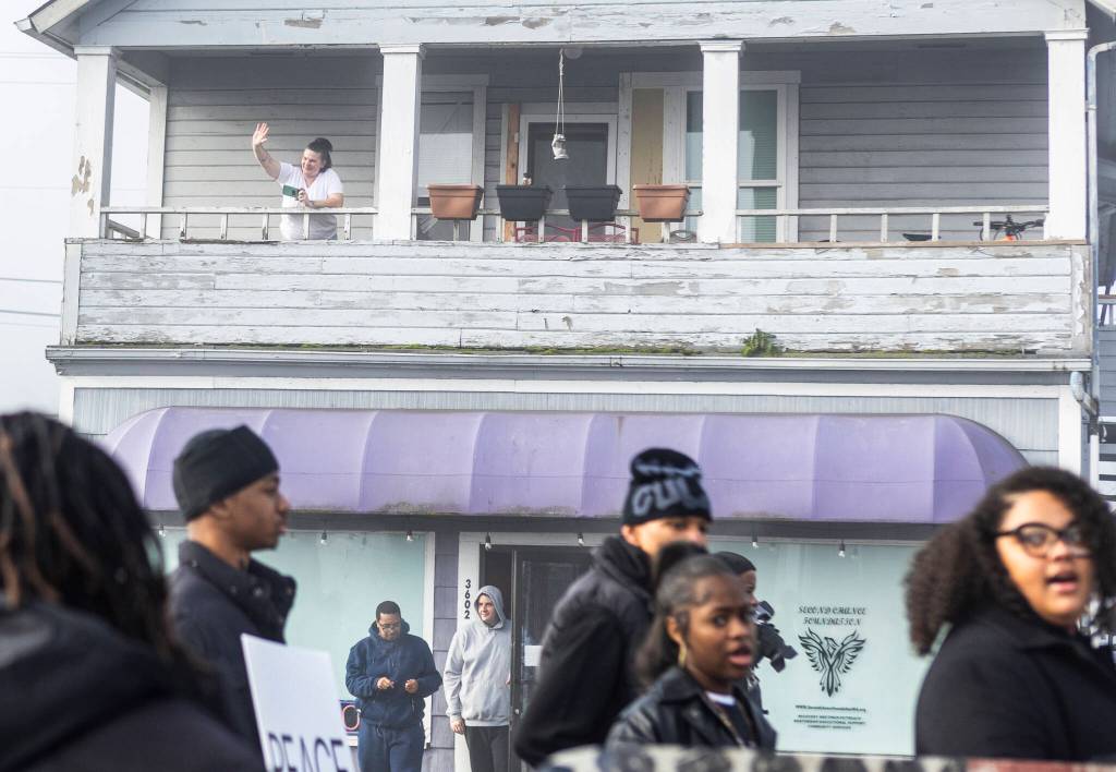 People wave at those participating in a Martin Luther King Jr. Day march on Monday, Jan. 19, 2026, in Everett, Washington. (Olivia Vanni / The Herald)