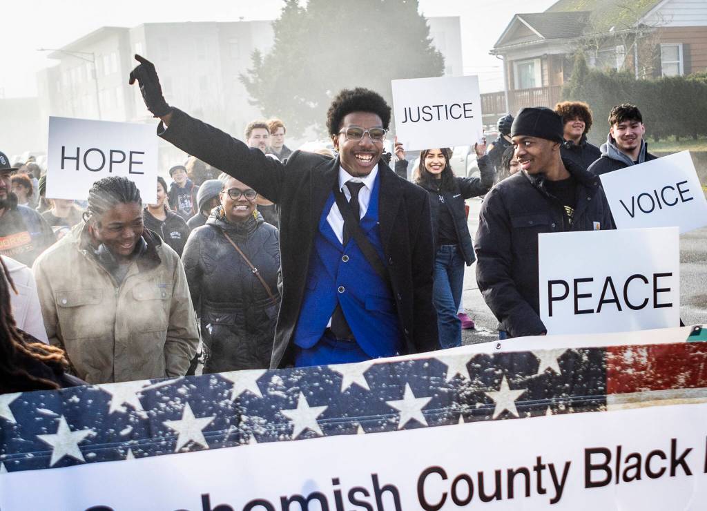 Noah Jackson jumps while walking along Colby Avenue during a Martin Luther King Jr. Day march on Monday, Jan. 19, 2026, in Everett, Washington. (Olivia Vanni / The Herald)
