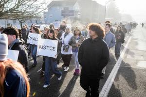 People walk along Colby Avenue in a Martin Luther King Jr. Day march on Monday, Jan. 19, 2026 in Everett, Washington. (Olivia Vanni / The Herald)