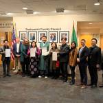 Mukilteo City Council member Jason Moon (center) stands with his parents, Washingtons Korean consul general and members of the Snohomish County Council, holding the resolution recognizing Korean American Day on Jan. 13, 2026. (Taylor Scott Richmond / The Herald)