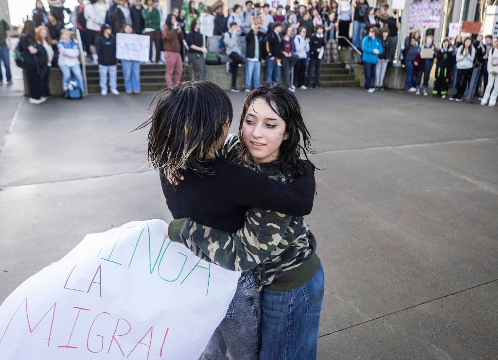 Cynthia Espinoza, right, and Liliana P., left, dance to huapango music during a walkout rally in protest of ICE outside of the Snohomish County Courthouse on Tuesday, Jan. 13, 2026, in Everett, Washington. (Olivia Vanni / The Herald)