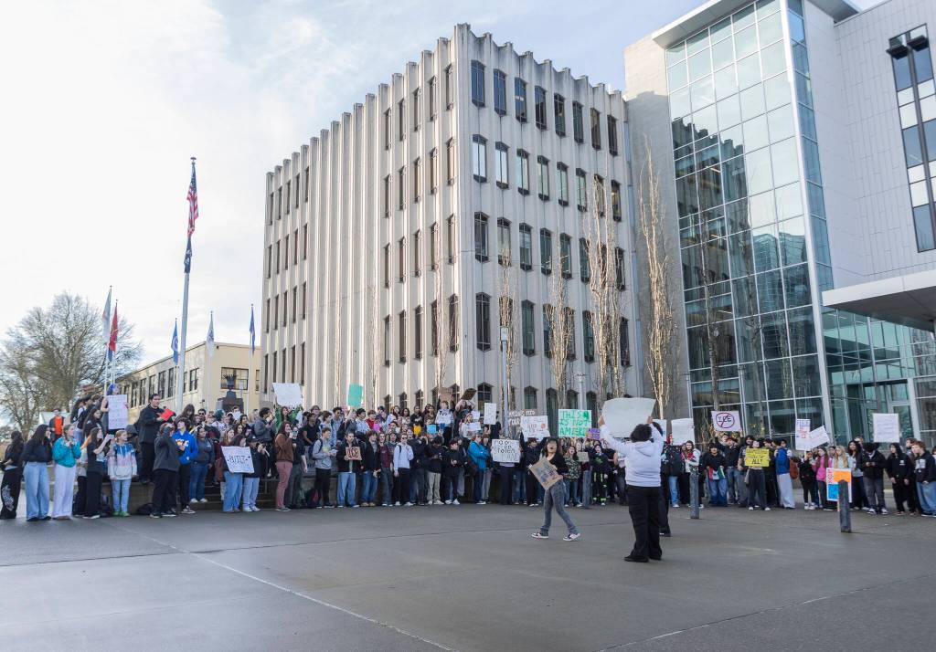 Over a hundred students from Everett High School gather outside of the Snohomish County Courthouse to protest ICE after a walkout from the school on Tuesday, Jan. 13, 2026, in Everett, Washington. (Olivia Vanni / The Herald)